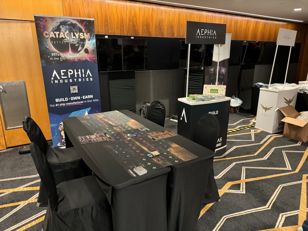 Our booth and game table at the IMPACT Summit in September 2024